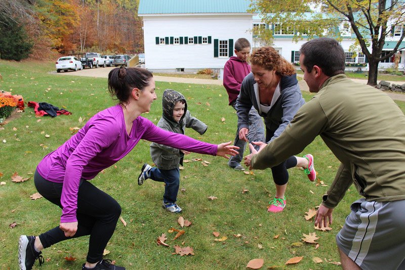Kate and James' family play games and get some exercise together on the grassy lawn at Hardy Farm before their 2013 wedding